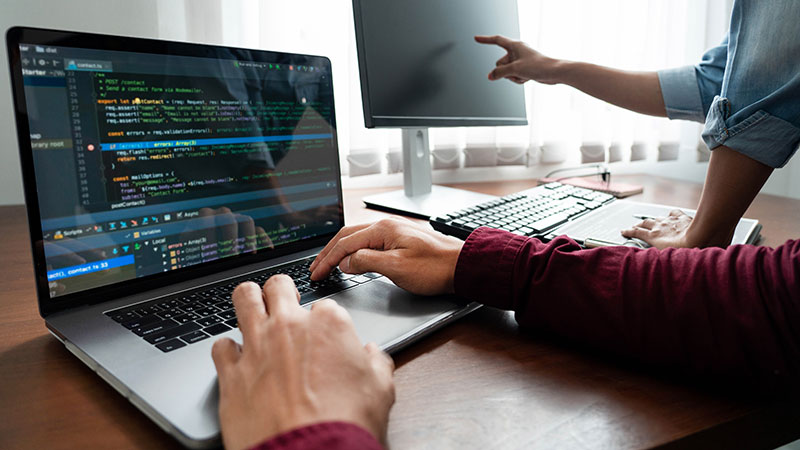 two people working on computers together