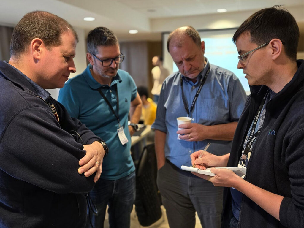 Group of people discussing and item on a paper.